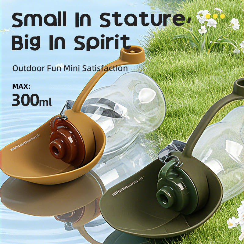 Dog drinking from Pawlyn packable silicone bottle outdoors